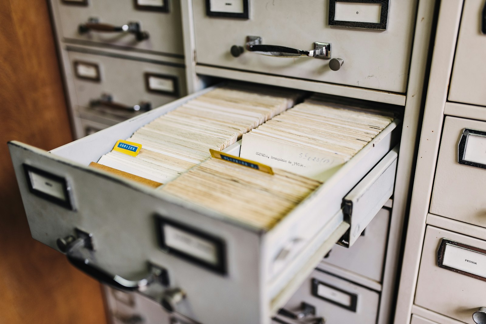 A file cabinet holding organized paper records